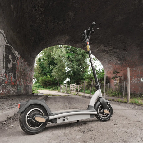 Electric scooter parked beneath a railway arch