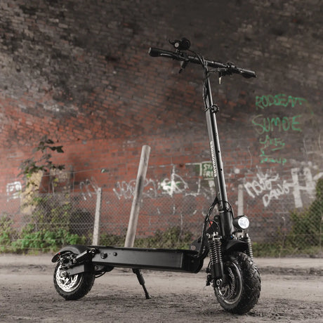 Electric scooter parked beneath a graffiti-covered arch