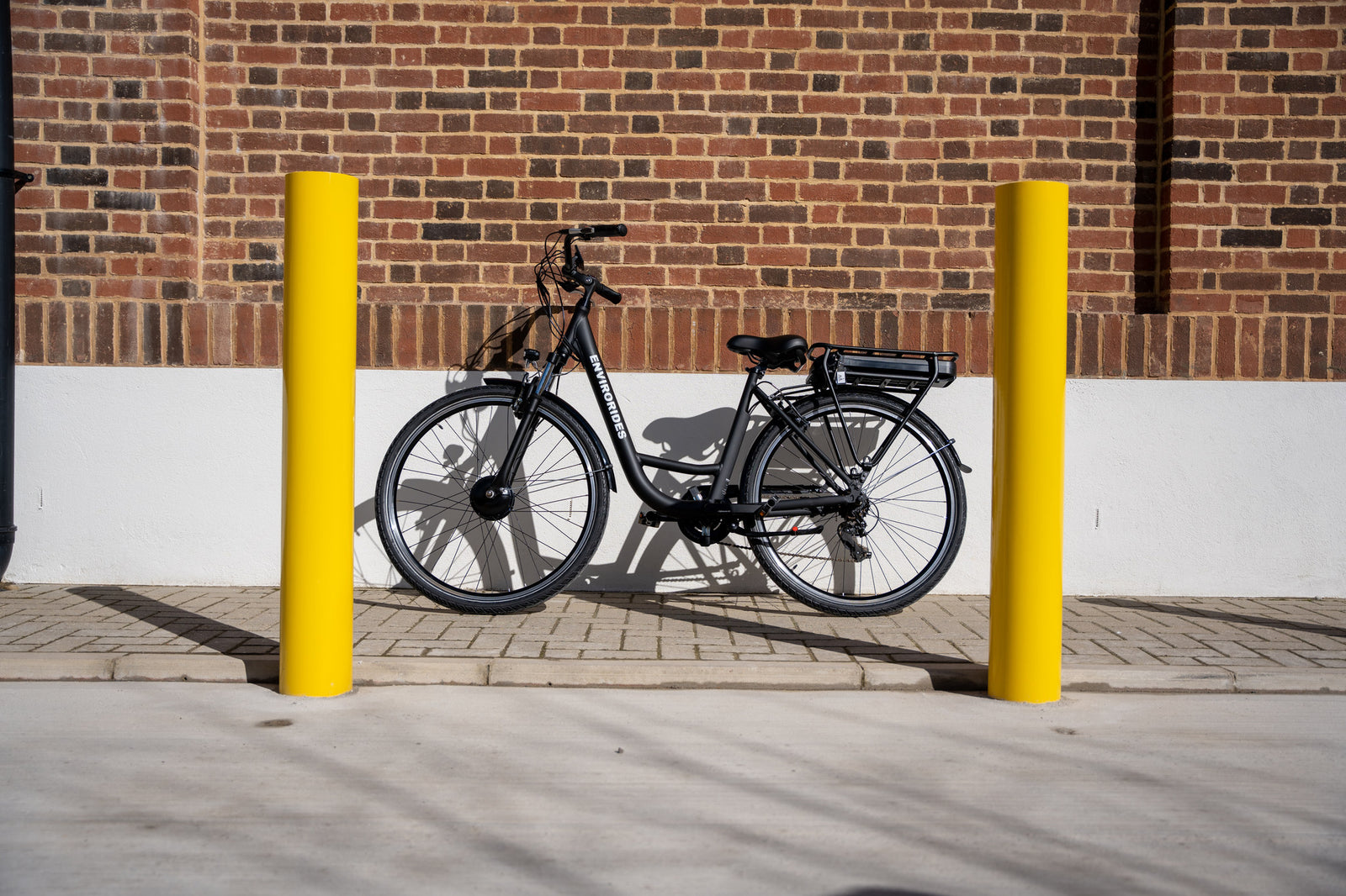 An EnviroRides eBike between two posts on a pavement